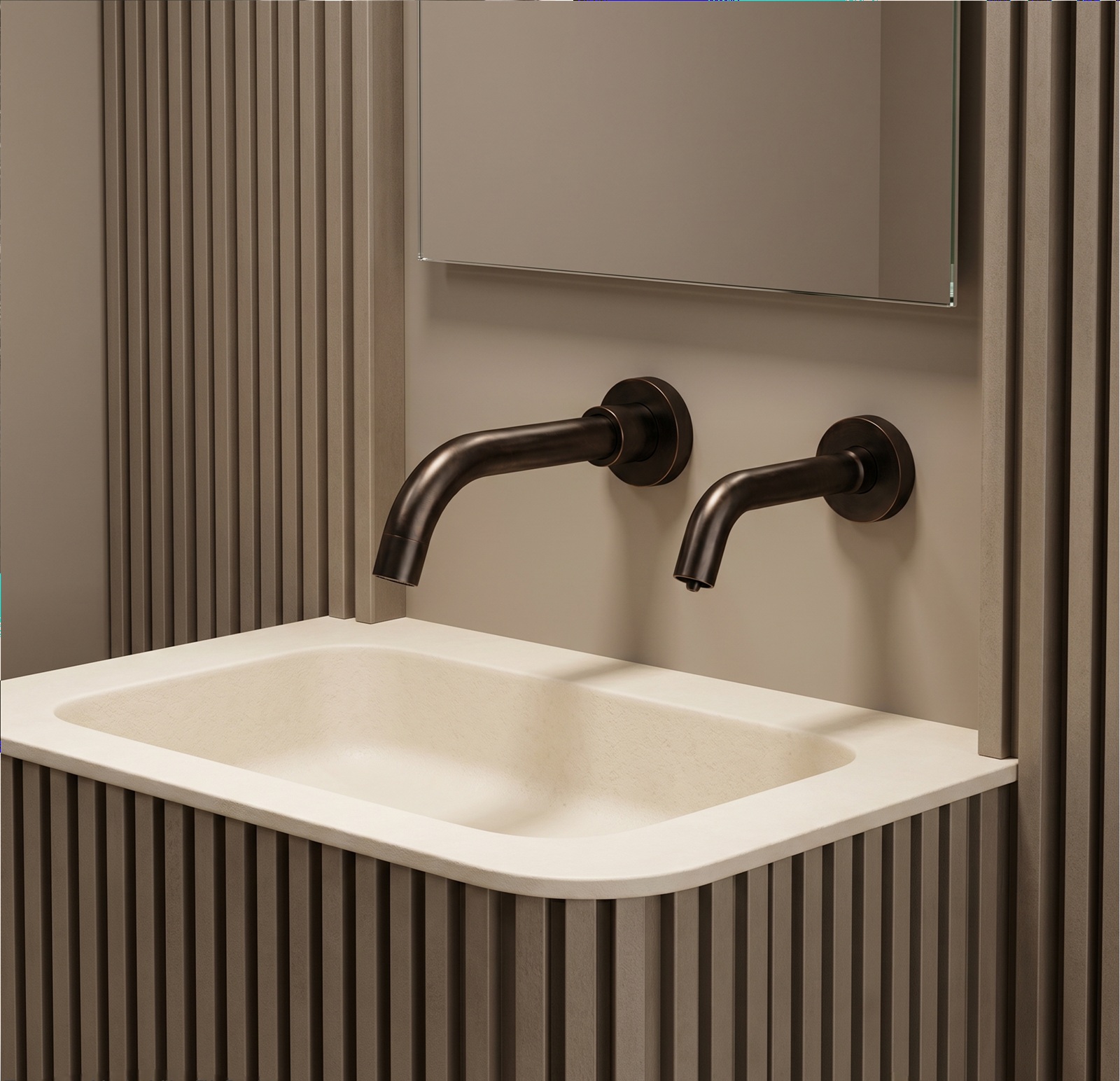 Oil-rubbed bronze dual wall-mounted faucet model installed above an integrated cream sink with fluted wall panels and modern mirror backdrop